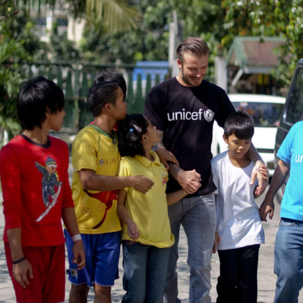UNICEF Goodwill Ambassador David Beckham is accompanied by children and a UNICEF staff member as he tours a UNICEF-supported centre for children who formerly lived on the streets, in Manila, the capital.