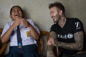 David Beckham laughing with a girl